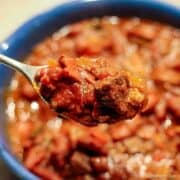 Stew Meat Chili in a spoon over a blue bowl