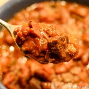 Stew Meat Chili in a spoon over a blue bowl