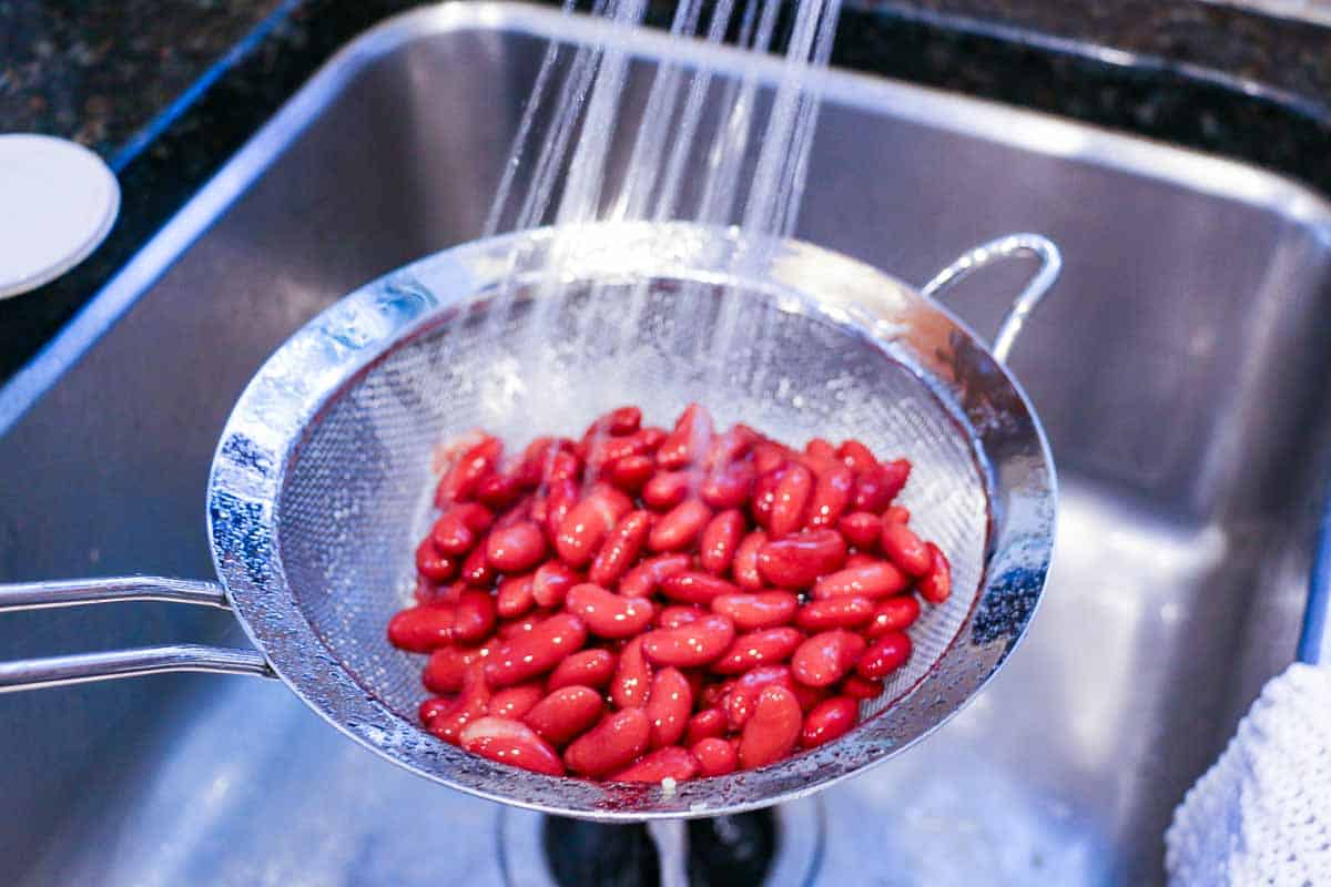 rinsing red beans under running water