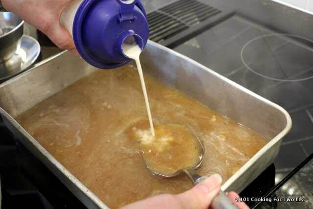 image of adding flour mixture to a pan while making gravy