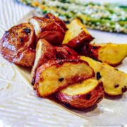 Roasted baby potatoes on a white plate