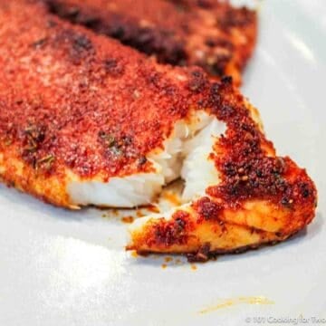 flacking Blackened Tilapia on a white plate