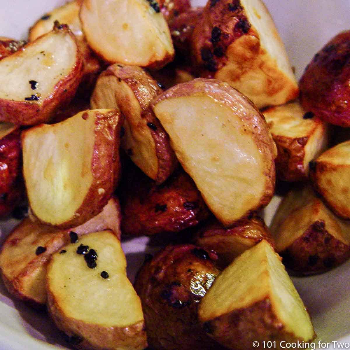 cooked red potatoes in white bowl