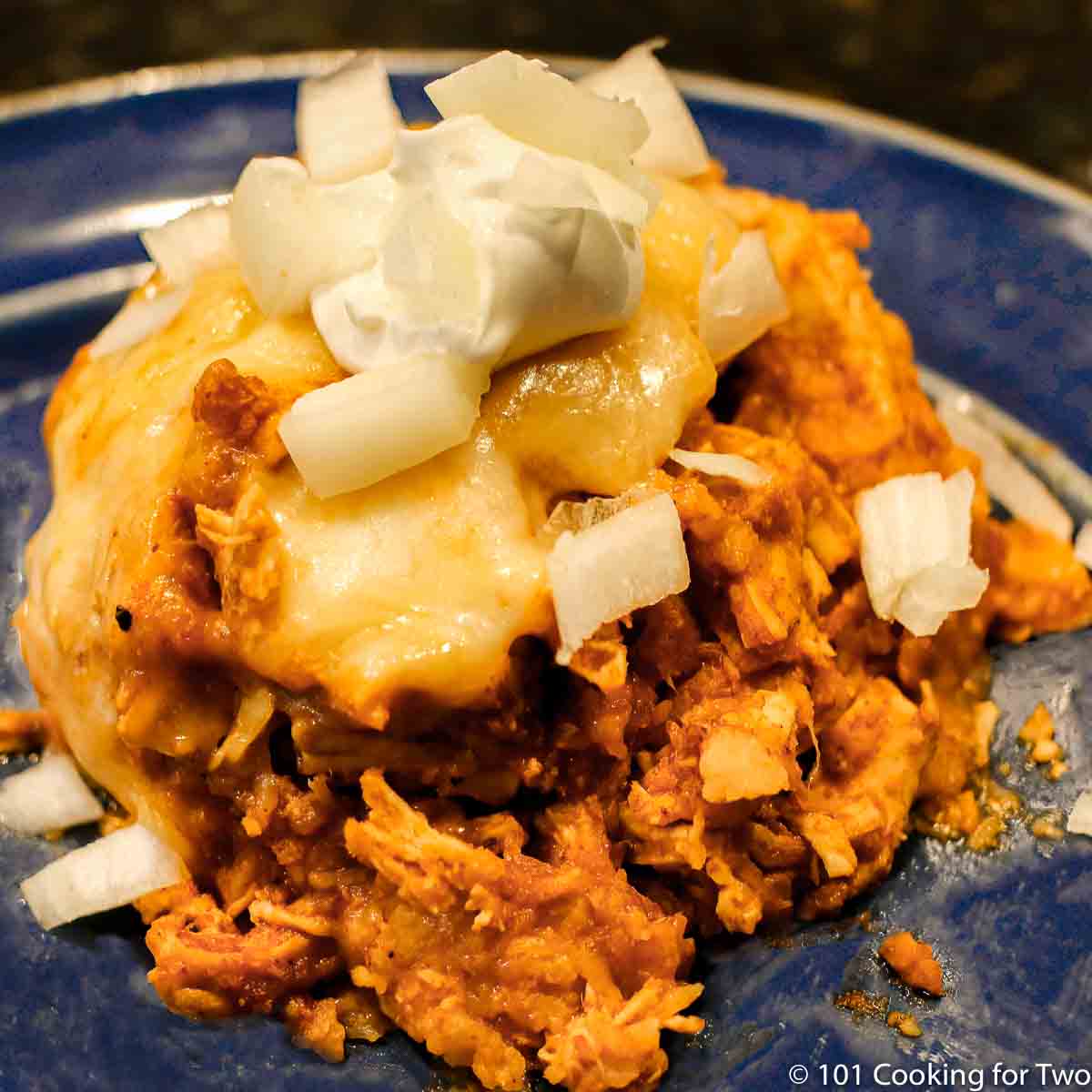 chicken enchilada casserole on blue plate