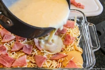 pouring sauce over layer in the casserole