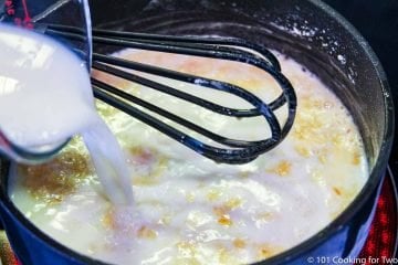 Add milk to the saucepan with a whisk.