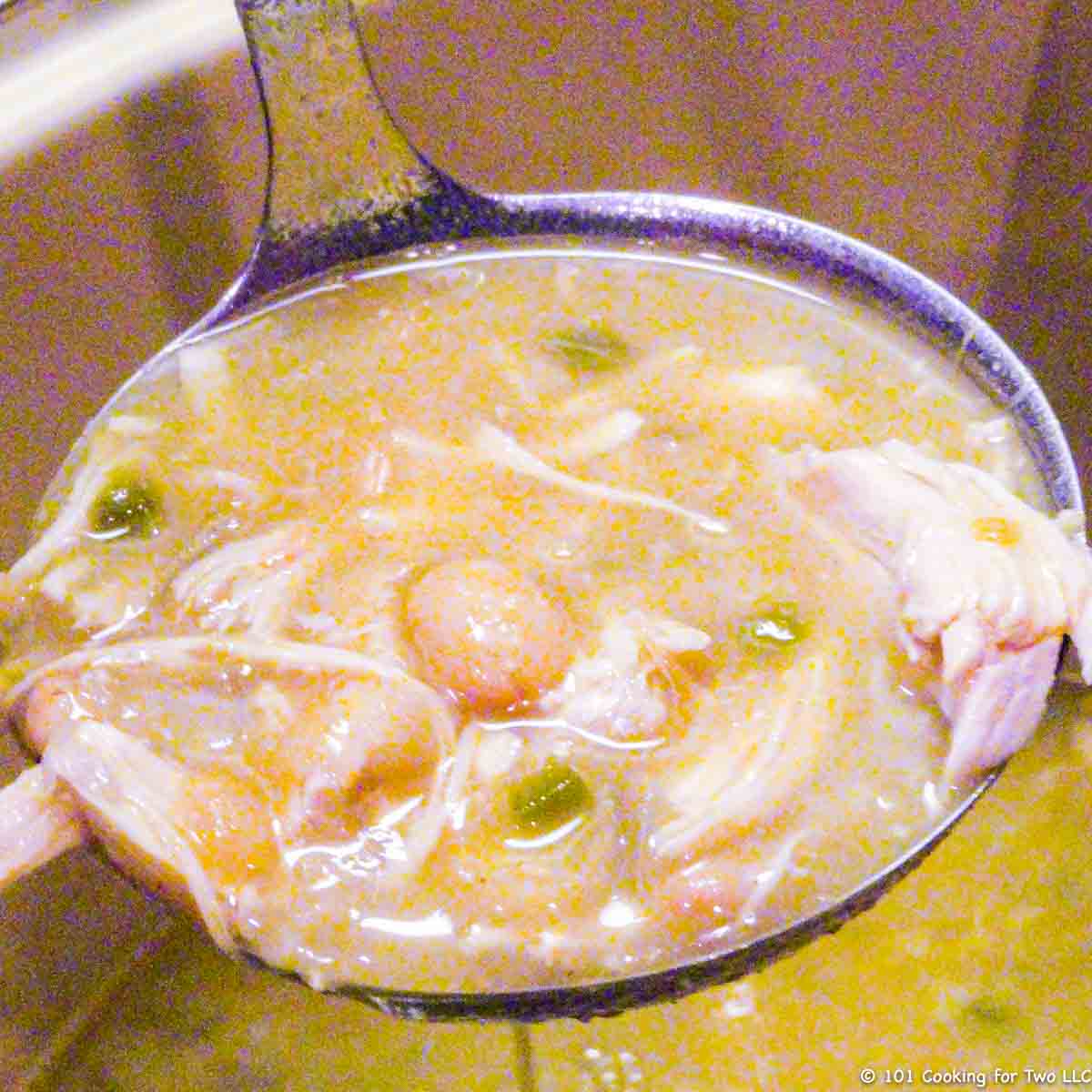 white chicken chili in a ladle.