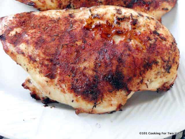 grilled blackened chicken breast on white plate