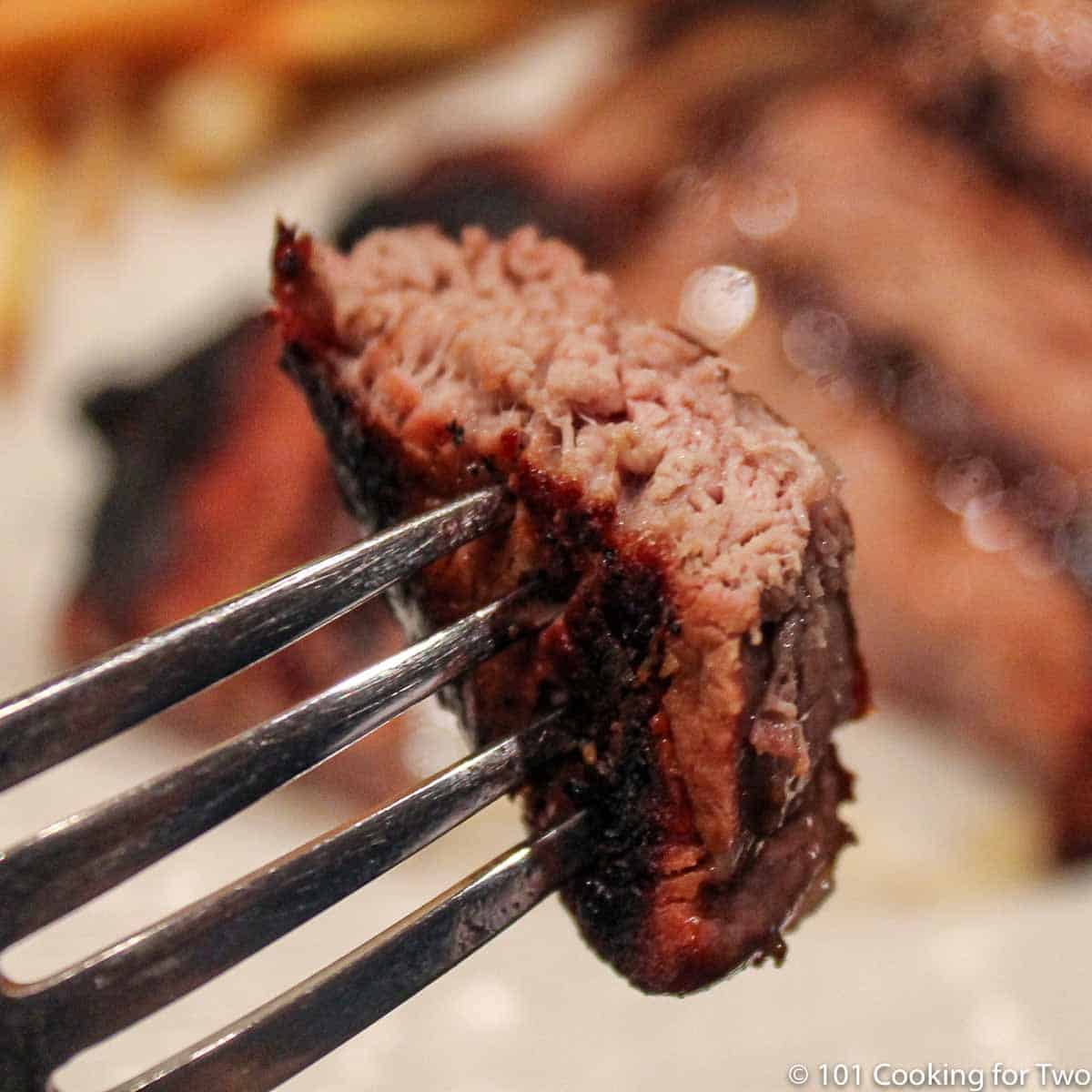 bite of steak on fork.
