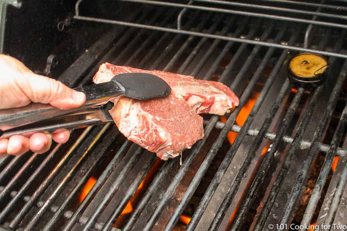 porterhouse steak going onto direct heat.