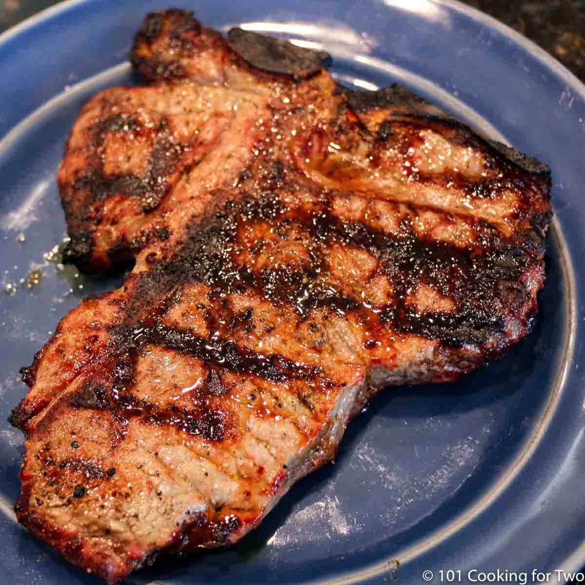 porterhouse steak on blue plate.
