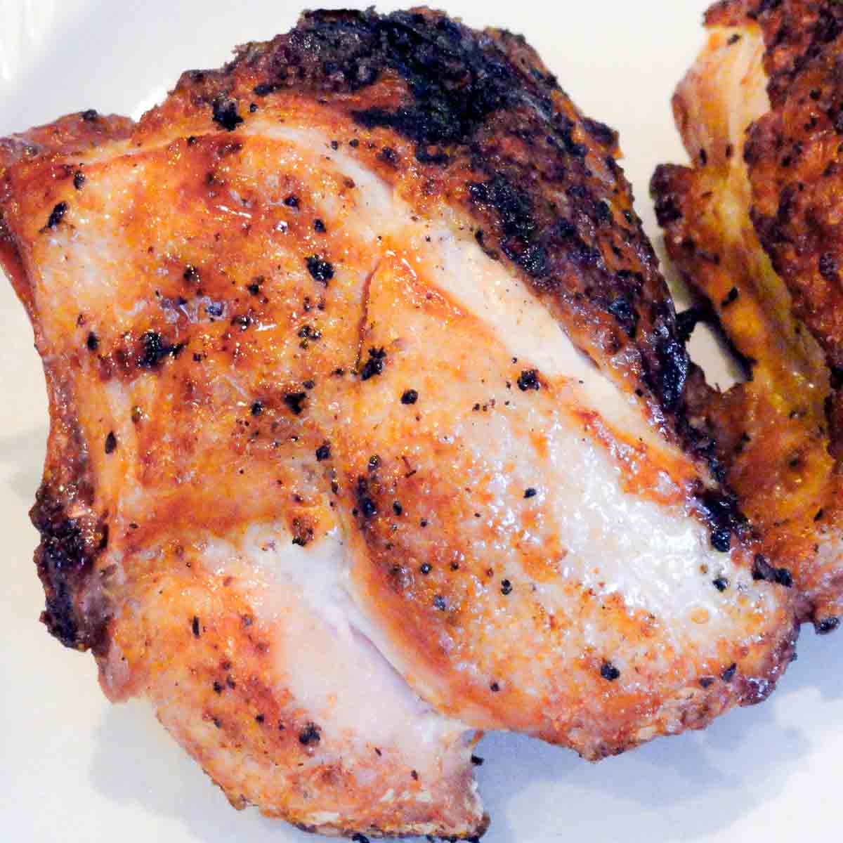 Crispy Garlic Grilled Chicken Breasts on a white plate.