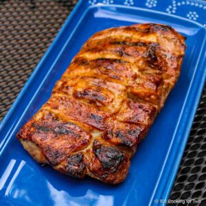 Grilled boneless ribs on a blue plate.