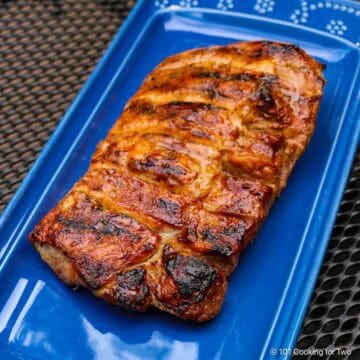 Grilled boneless ribs on a blue plate.