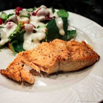 \salmon flaking on a plate with a salad