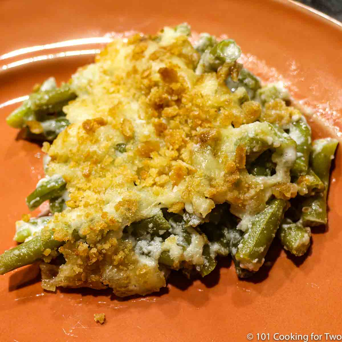 Closeup image of green bean casserole on an orange plate