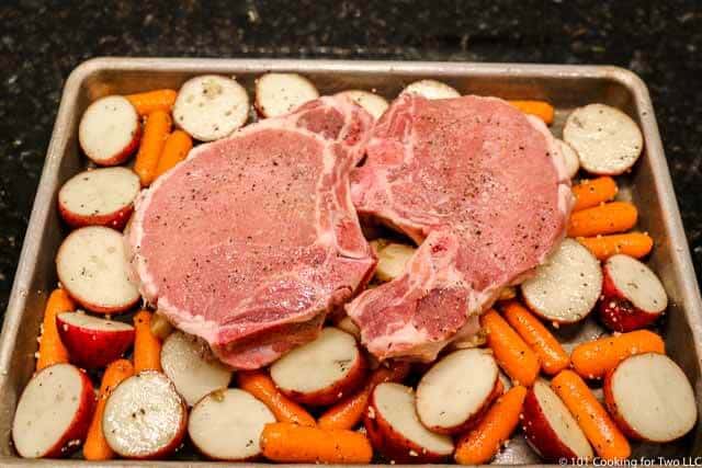 image of the dish ready to go into the oven with the pork chops on top