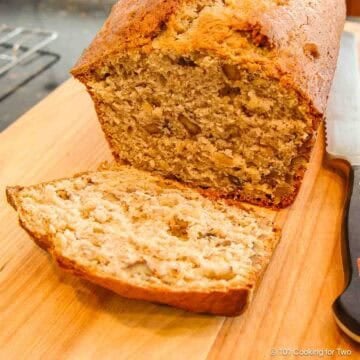 loaf of banana nut bread on a cutting board