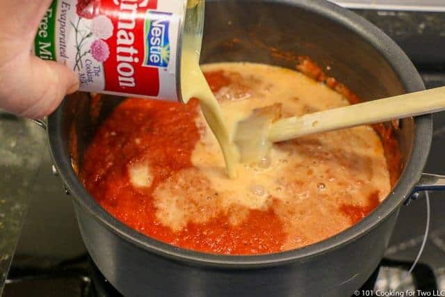 image of adding milk to the soup