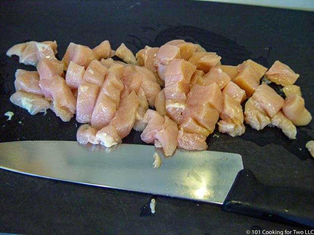 image of cubed chicken on a black chopping board