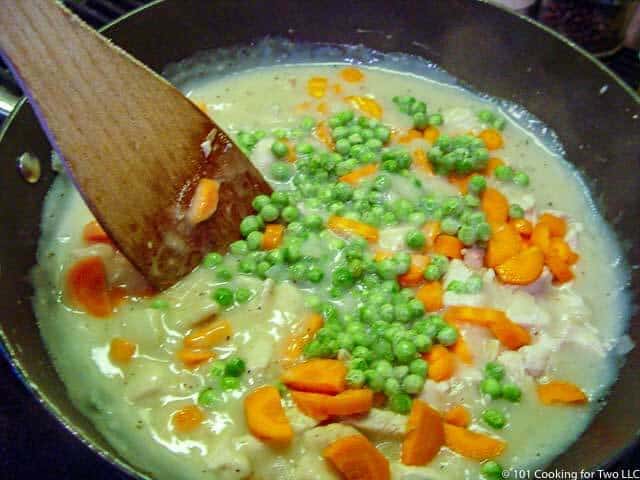 image of mixing the veggies and chicken into the gravy