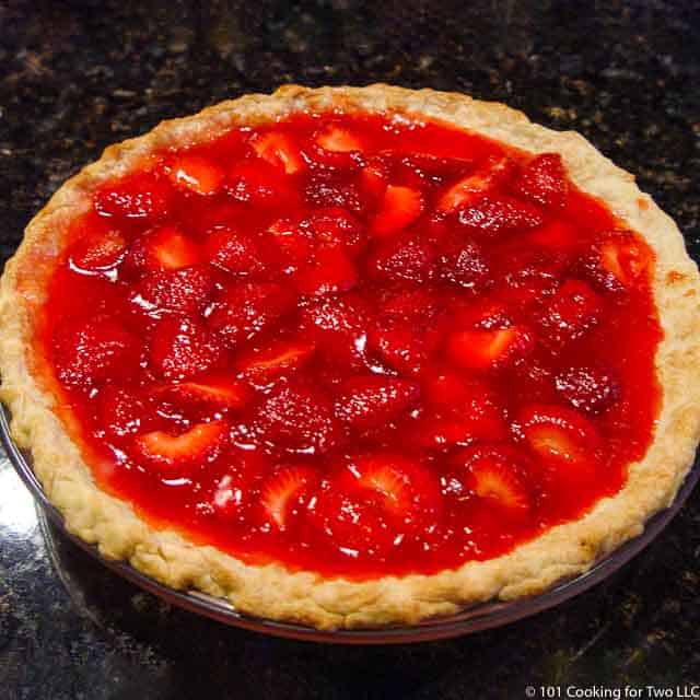 Image of a whole Fresh Strawberry Pie on a black counter