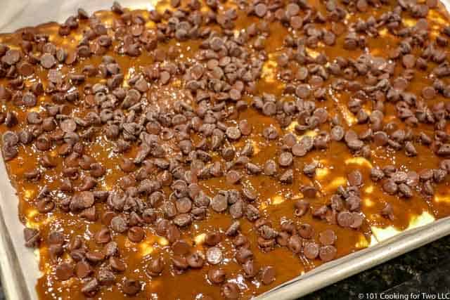 chocolate chips spread over the hot pan.