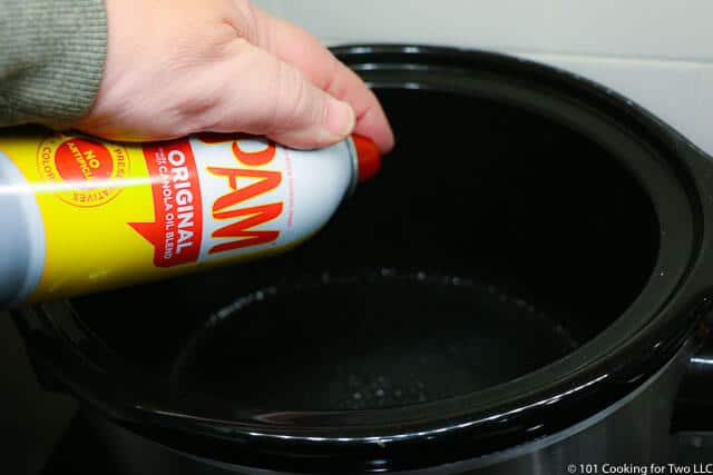 image of spray a smaller crock pot with PAM