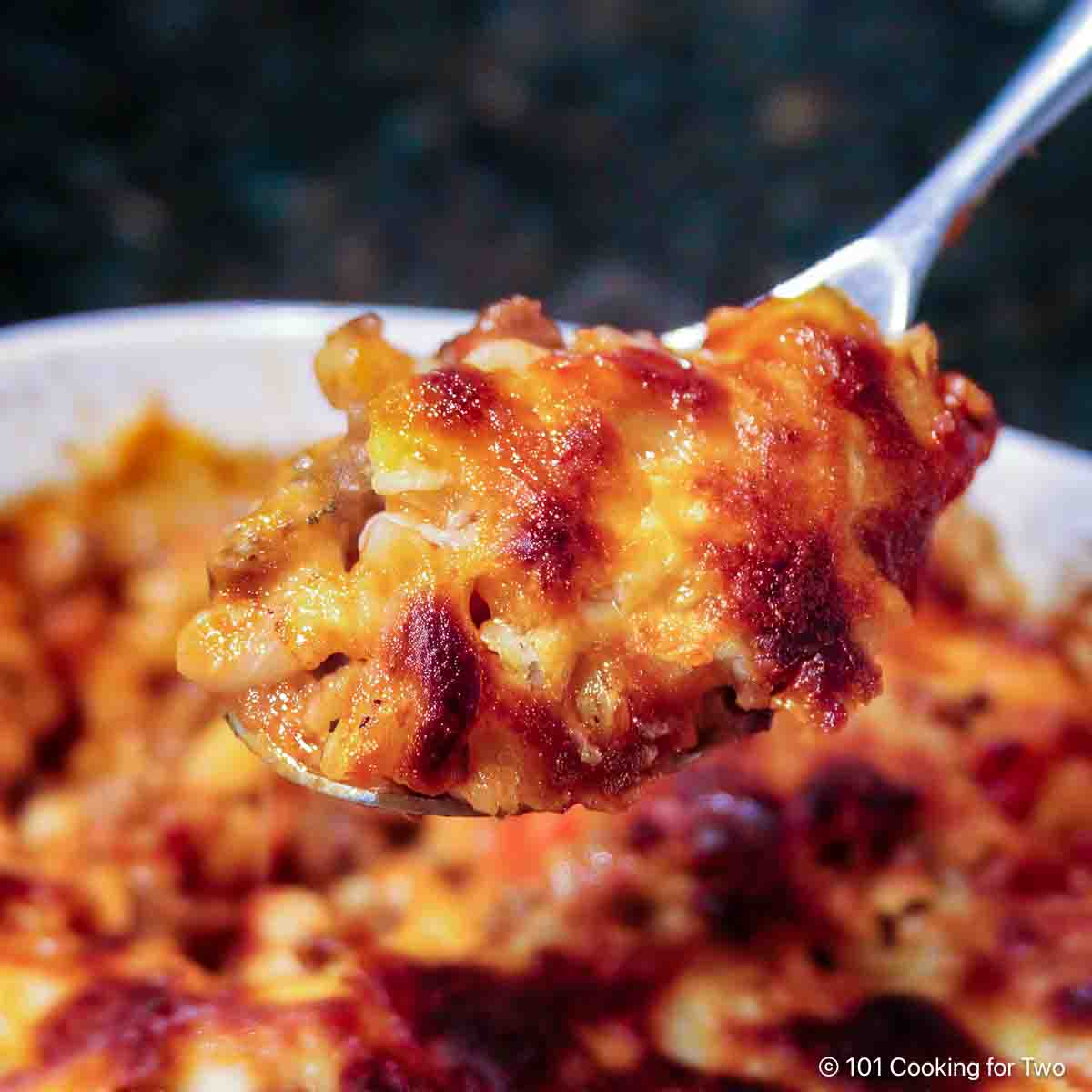 Cheesy American Goulash on a spoon