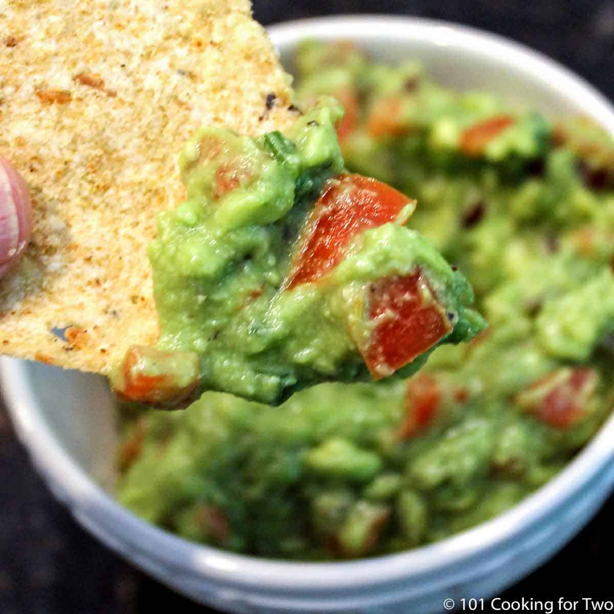 guacamole on a chip over a white bowl