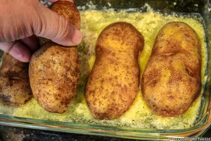 adding potatoes cut side down to pan
