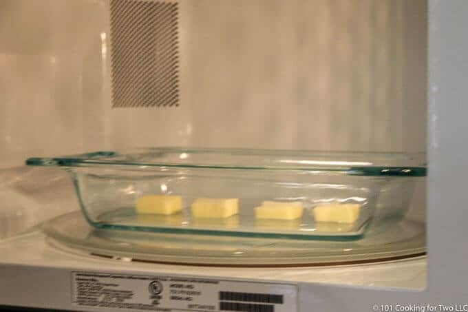 butter in glass baking dish in microwave