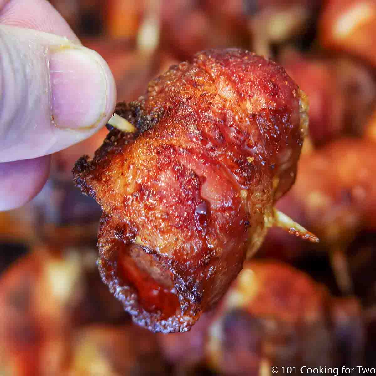 bacon wrapped chicken on a toothpick.
