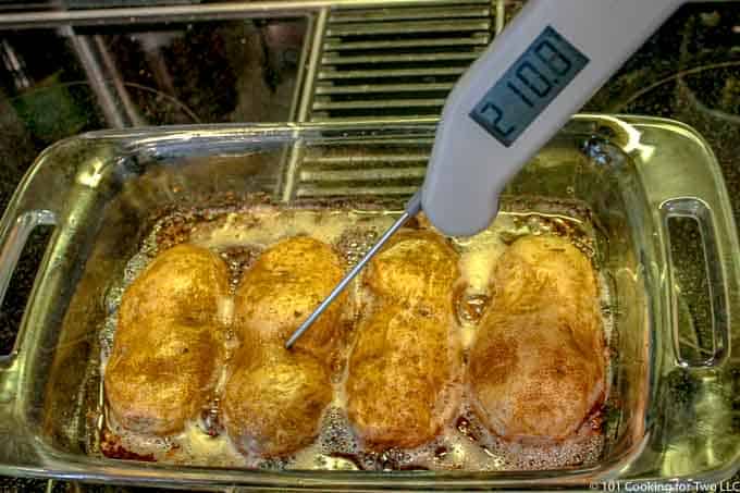 cooked potatoes in baking dish with thermometer