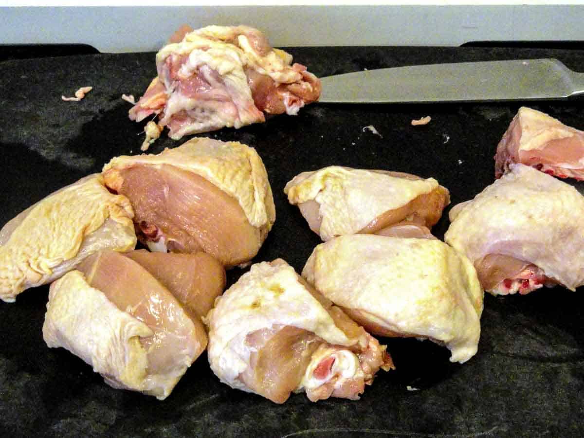 cutting chicken breasts into chunks.