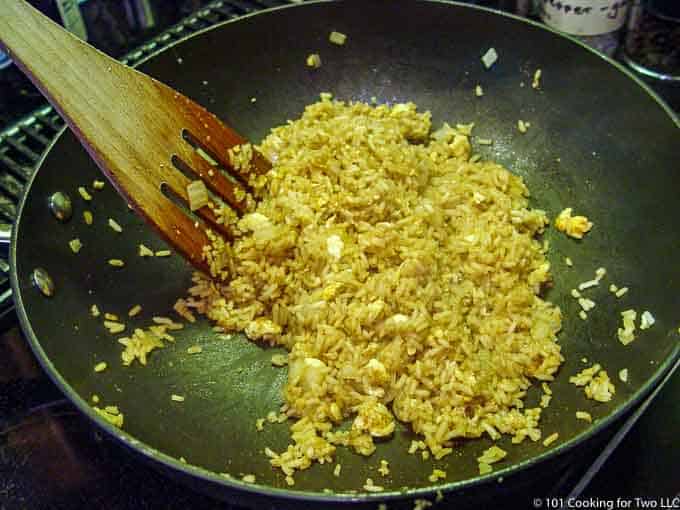 mixing the fried rice in a pan
