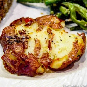 image of a smashed potato on a white plate