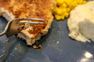 image of breaded pork chop cut with aa fork