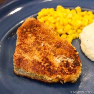 breaded pork chop on blue plate