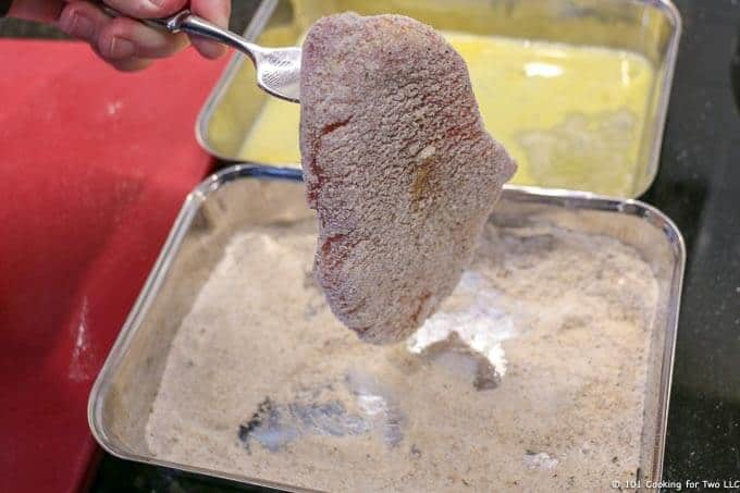 image of pork chop coming out of flour mixture