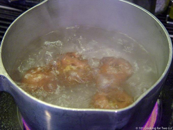 red potatoes in a pan of boiling water