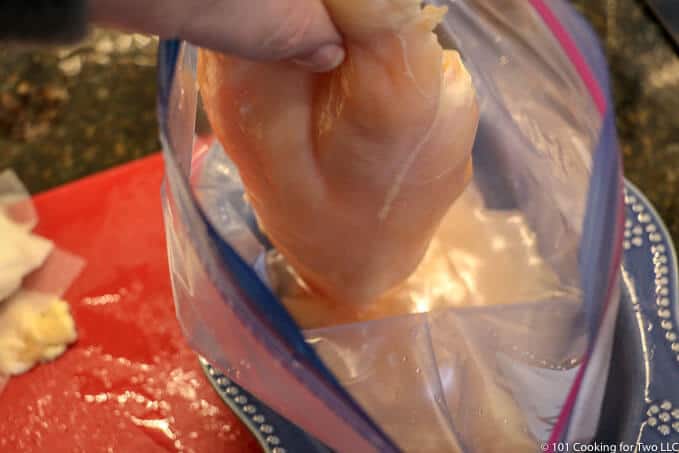 image of adding a chicken breast to brine