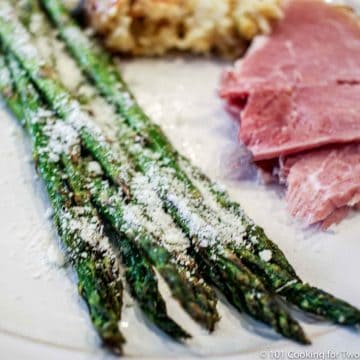 asparagus on a white plate with Parmansan