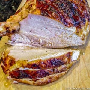 sliced grilled turkey breast on a board