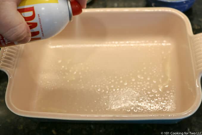 spraying a small baking dish with PAM
