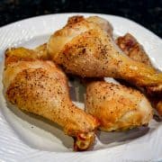 Baked chicken legs on a white plate