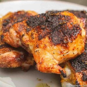 grilled chicken thigh on white plate