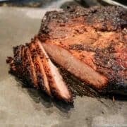 Cooked brisket on a gray board