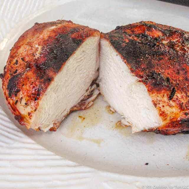 cut chicken breast on a white plate
