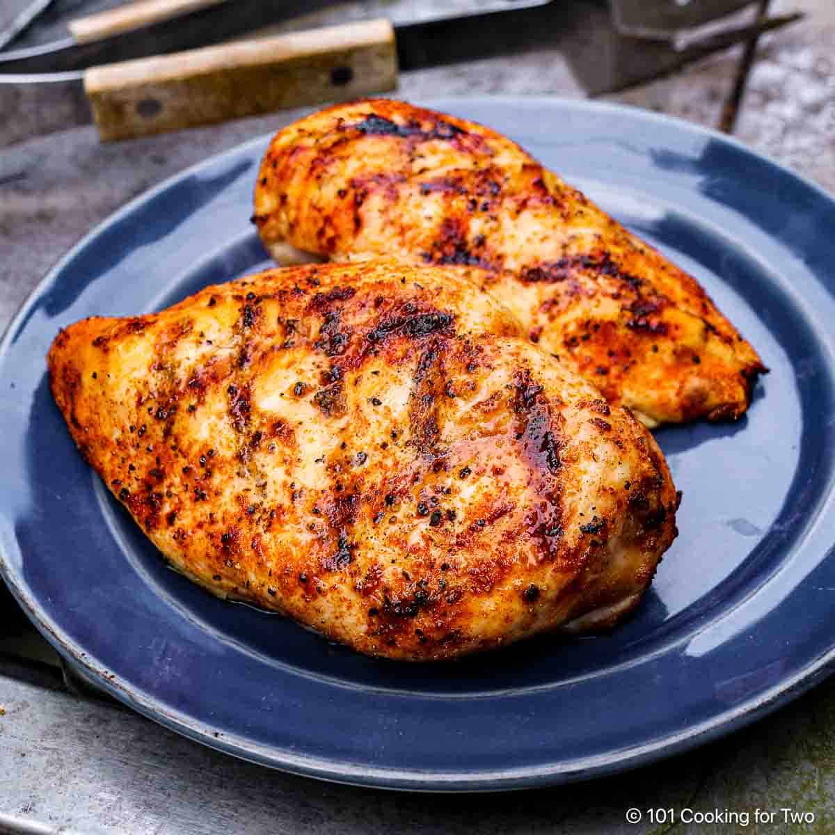 Grilled Chicken Breasts on a blue plate.